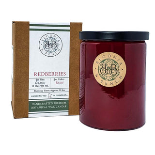 A jar candle with a black lid labeled "Begonia & Bench" sits beside a brown and white box featuring the same branding. The candle is in the Redberries™ scent, part of the 12oz finely crafted collection by Begonia & Bench®. The text on the box reads: "Redberries, Grand 12 oz/355 ml, Ruby, Burning Time Approx. 90 hrs," and also highlights that it is a "Handcrafted Premium Botanical Wax Scented Candle.