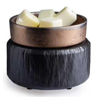 Introducing the Classic 2-in-1 Candle Warmer, featuring a textured black base and a metallic bronze dish on top, designed to hold four creamy white fragrance wax melts. This warmer showcases a modern, rustic design with both matte and shimmering finishes, making it the perfect addition to enhance your home decor.