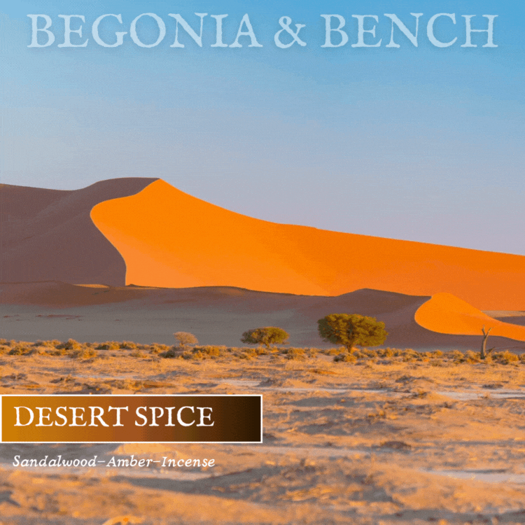 An image showcases expansive orange sand dunes beneath a clear sky, with desert vegetation in the foreground. The text "BEGONIA & BENCH®" is displayed at the top. At the bottom, a brown box features the words "DESERT SPICE™," with "Sandalwood-Amber-Incense" written underneath. Ideal for creating a cozy fall candle ambiance, this product is Desert Spice™ - 9oz. Amber Jar Candle by Begonia & Bench®.