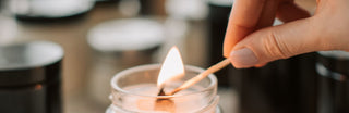 close up of lighting a wooden wick candle.