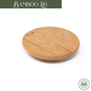 A round Bamboo Lid displayed against a white backdrop. The lid showcases a smooth, polished surface featuring natural bamboo grain patterns. In the top left corner of the image, "Bamboo Lid" is written in white text on a green background, making it an ideal addition to your fall candle. The bottom right corner highlights a circular logo with the brand name "Econic Ware.